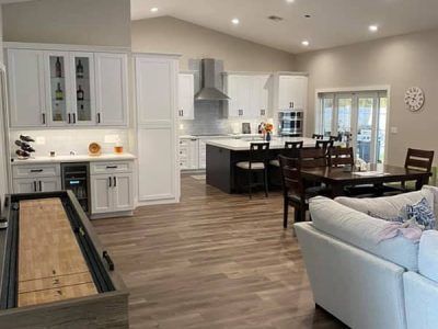 A living room filled with furniture and a shuffleboard table.