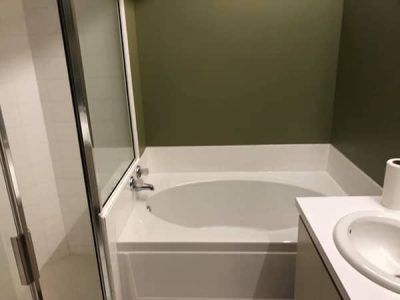 A bathroom with a bathtub and a sink.