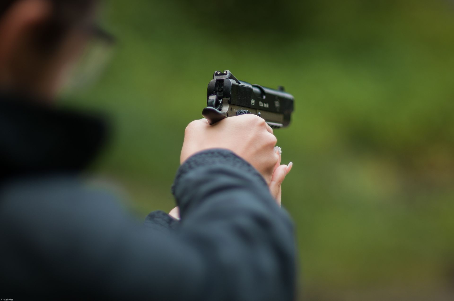 Person holding a black handgun, representing firearm or weapon offense in Florida.