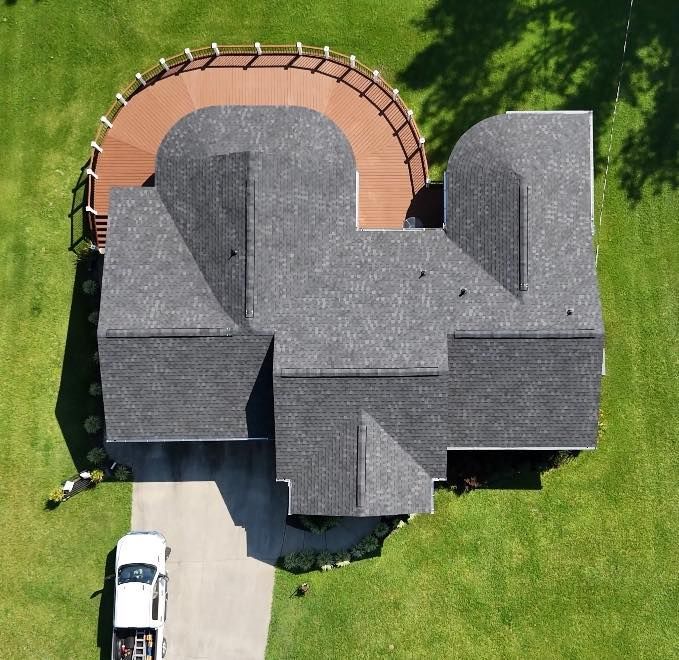 An aerial view of a house with a truck parked in front of it