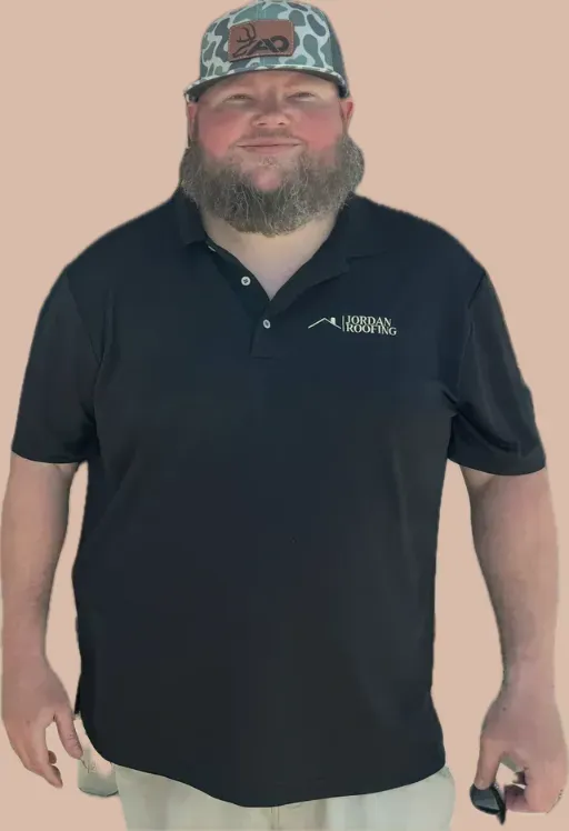 A man with a beard wearing a black polo shirt