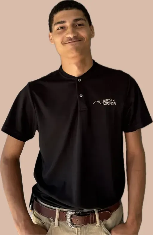 A young man wearing a black polo shirt and khaki pants