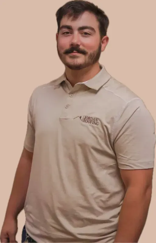 A man with a beard is wearing a tan polo shirt