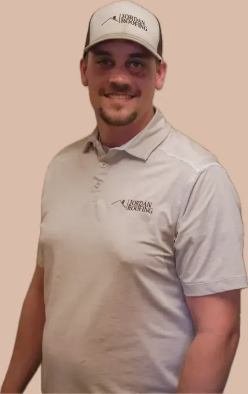 A man wearing a hat and a polo shirt is smiling for the camera.