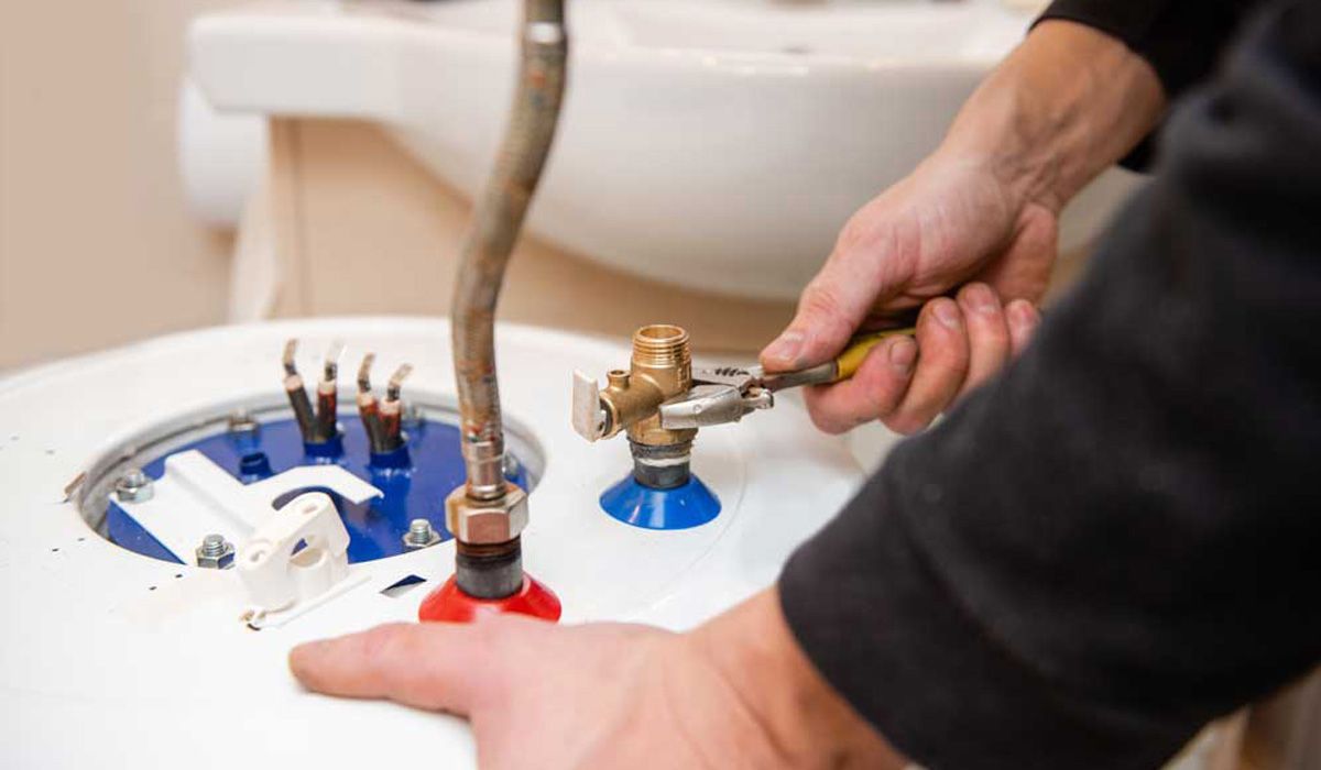 man repairing a water heater