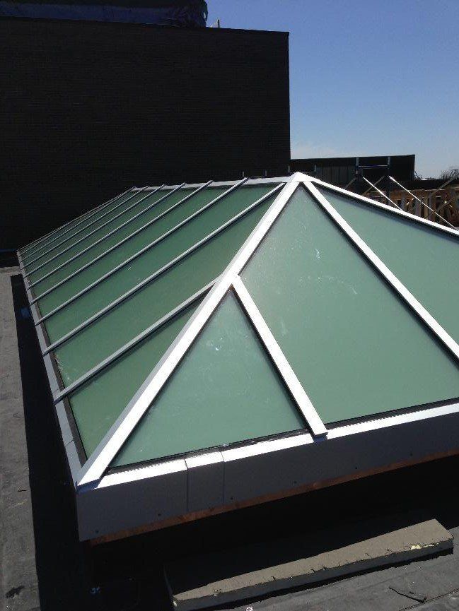 A pyramid shaped skylight on the roof of a building