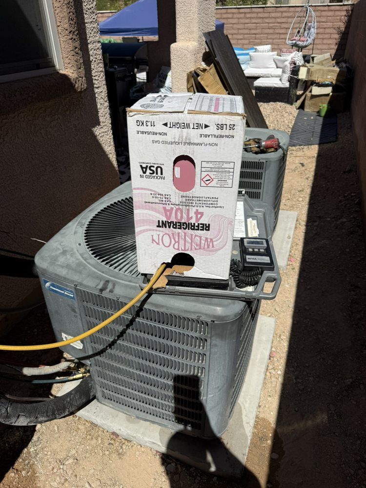 A refrigerant canister sits on top of an outdoor residential air conditioning unit.