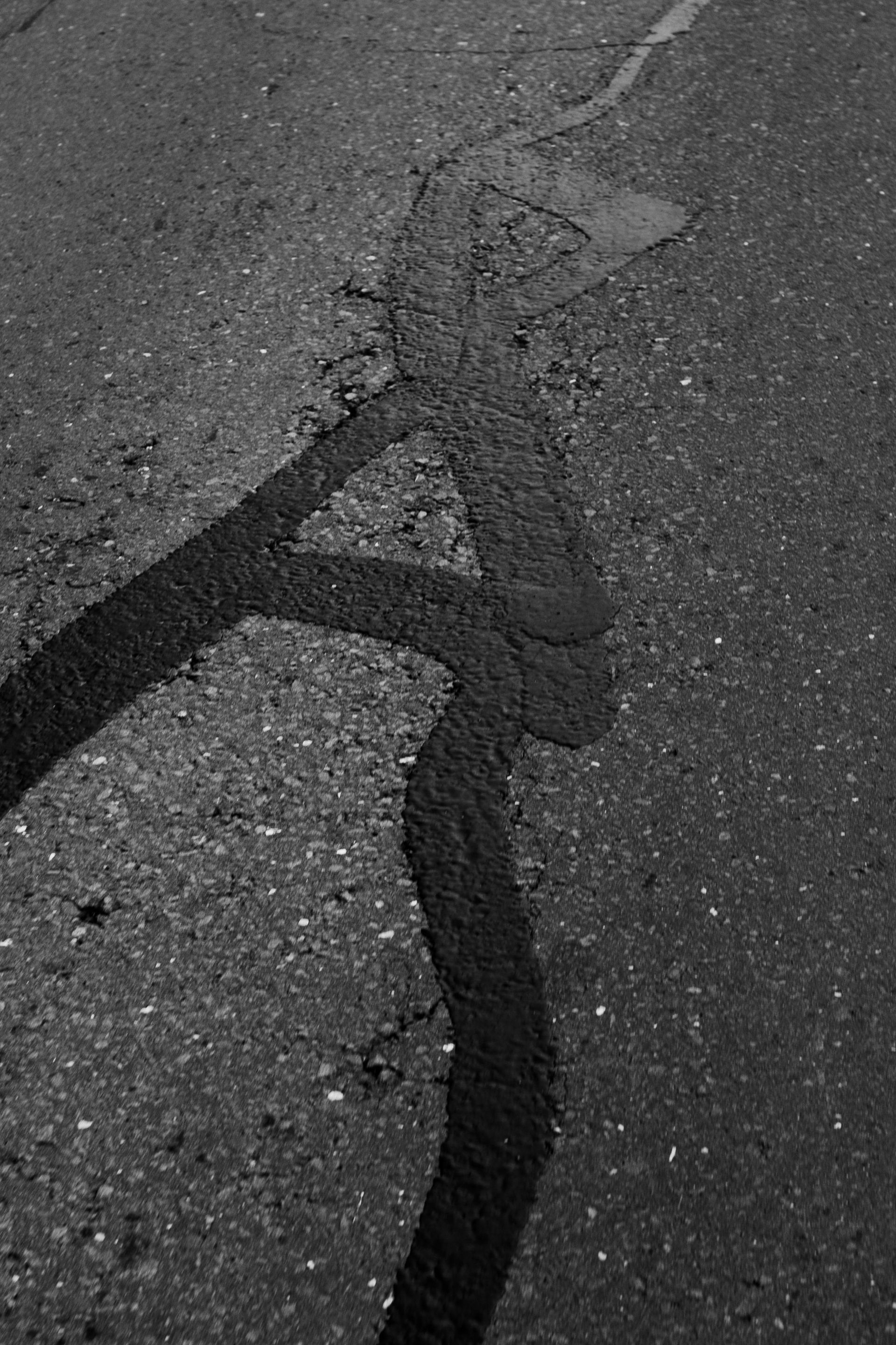 Close-up of a cracked dark surface with a long, jagged fissure running diagonally.