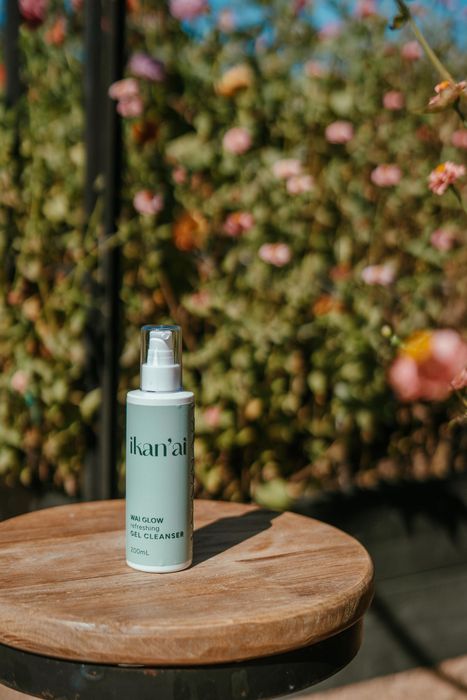 Small mint-green spray bottle on a wooden stool outdoors — Ikan'ai In Bowral, NSW