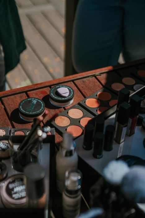 Makeup palette and brushes on a table in a dimly lit setting — Ikan'ai In Bowral, NSW