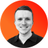 A man in a black shirt is smiling in an orange circle