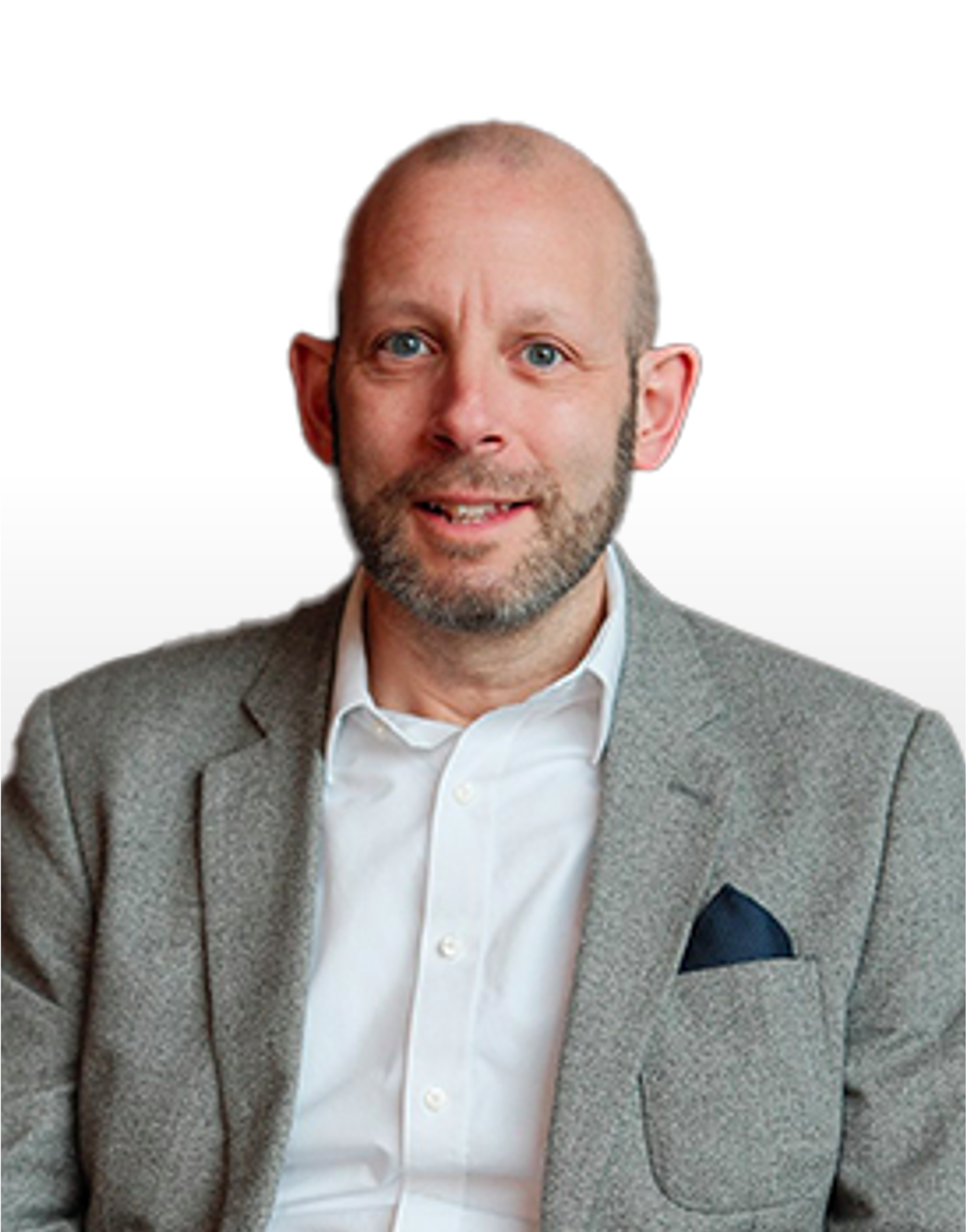 A man with a beard is wearing a suit jacket and a white shirt.