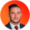 A man in a suit and tie is in an orange circle