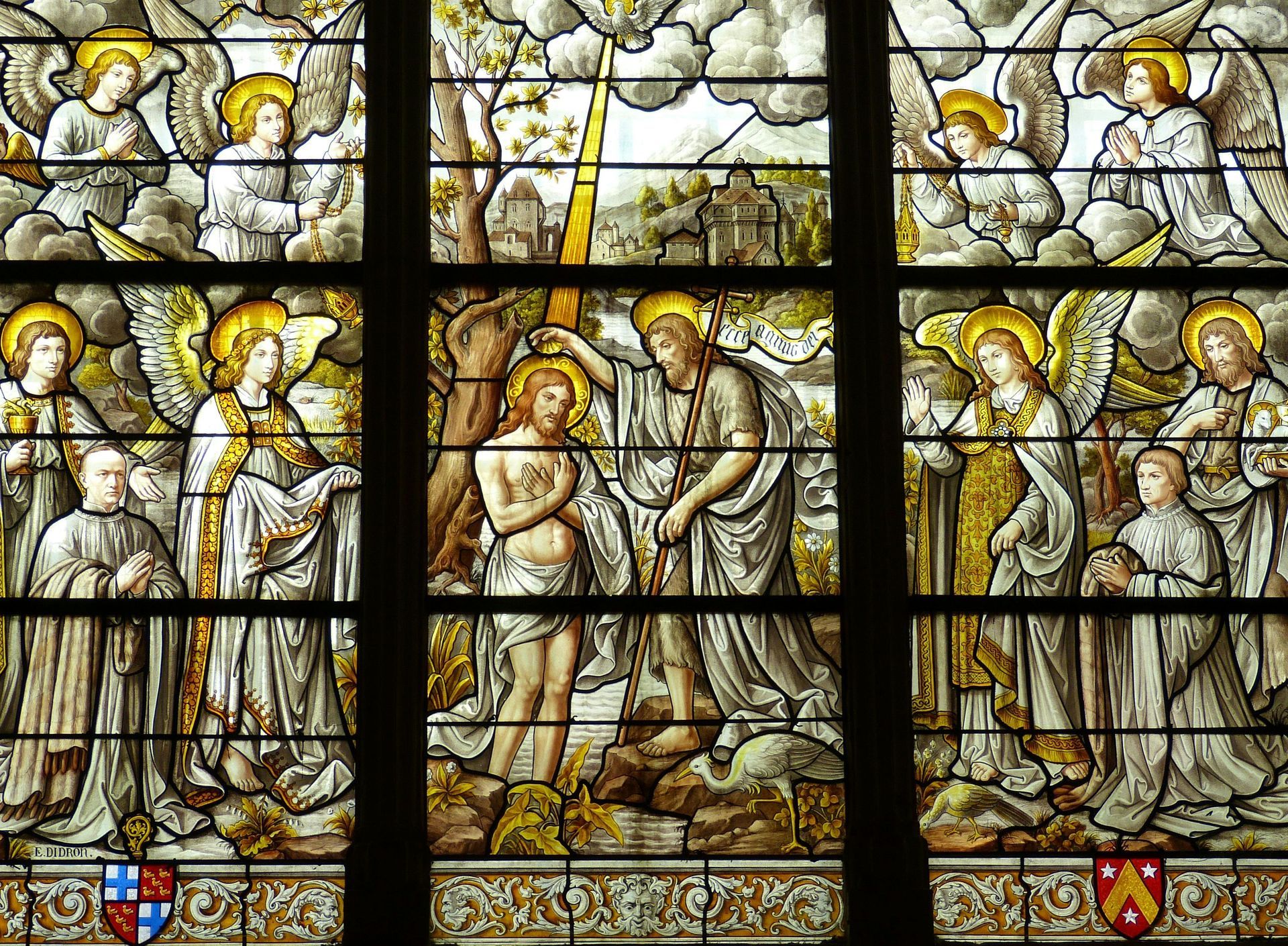 Stained glass window depicting Jesus' baptism by John, surrounded by angels.