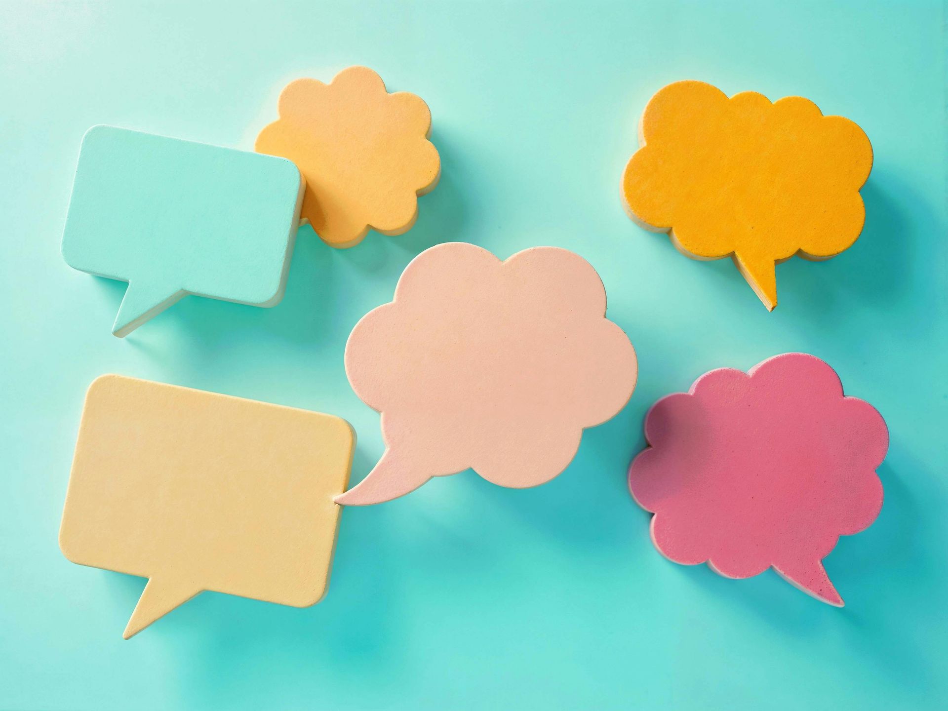 Colorful speech bubbles on a turquoise background, arranged in a scattered conversation-style layout
