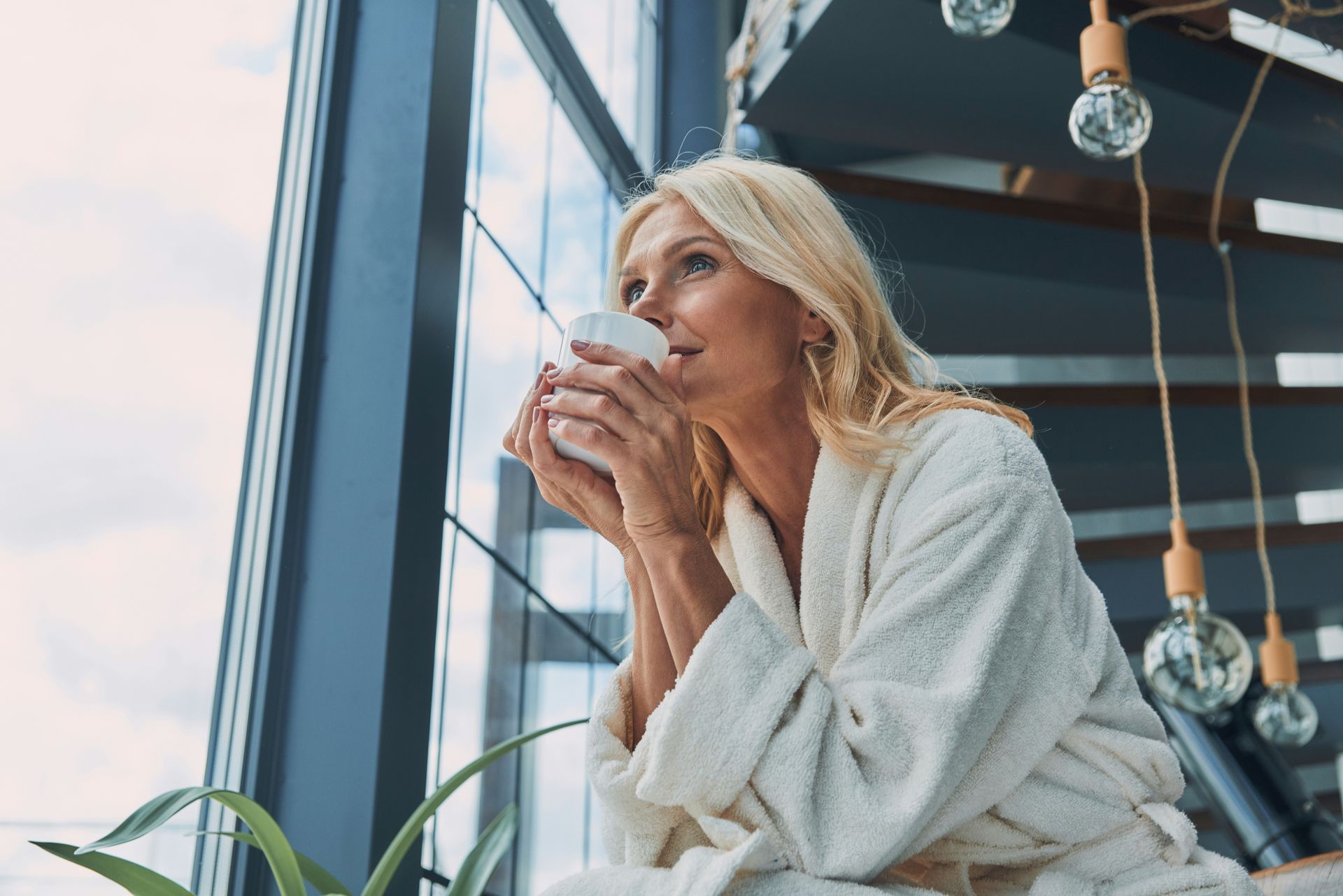 7 Mistakes People Make When Decluttering—And How to Avoid Them. A woman sorting items into donate, t