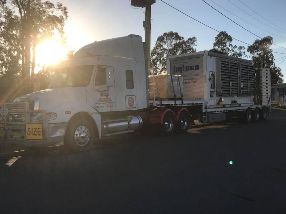 Semi Truck With a Trailer Attached to It is Parked on the Side of the Road — Pit Express in Tomago, NSW