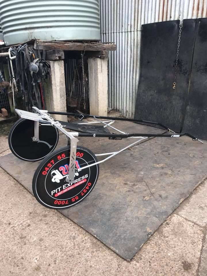 Horse Drawn Carriage is Sitting on Top of a Rubber Mat — Pit Express in Tomago, NSW