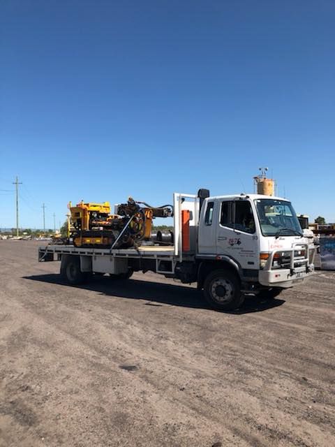 White Truck With a Yellow Crane on the Back is Parked in a Dirt Lot — Pit Express in Singleton, NSW