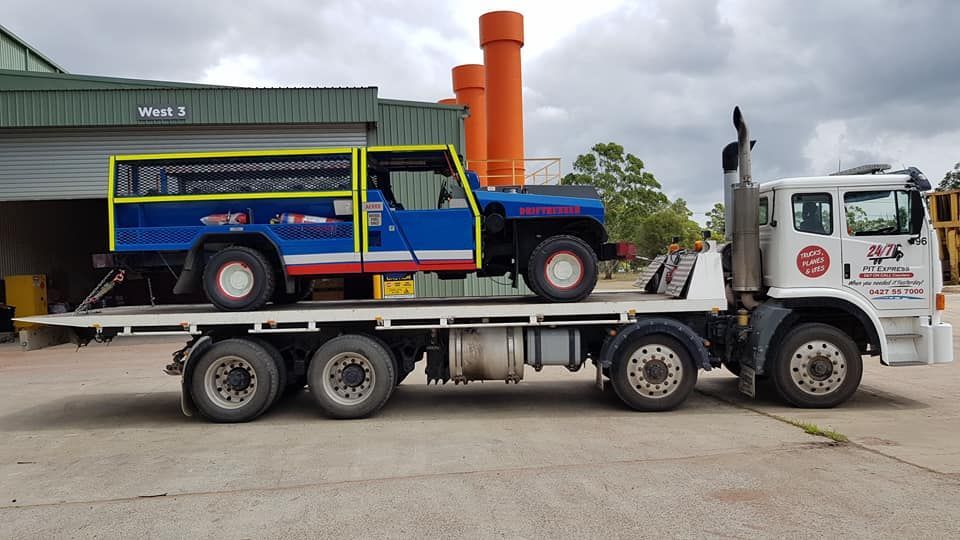 Tow Truck is Carrying a Blue and White Truck — Pit Express in Gosford, NSW