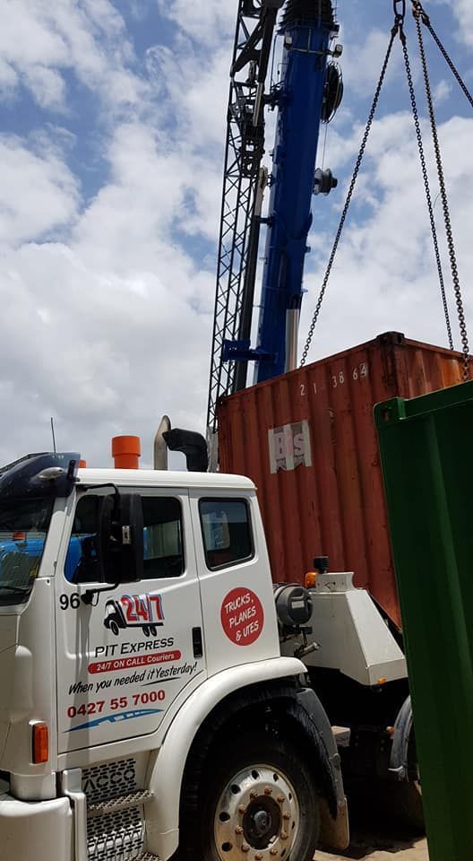 Truck With a Crane Attached to It is Lifting a Shipping Container — Pit Express in Gosford, NSW