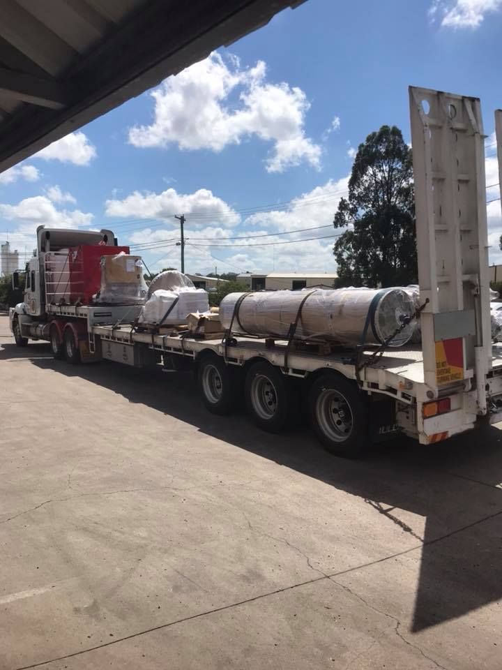 Semi Truck With a Flatbed Trailer is Parked in a Parking Lot — Pit Express in Gosford, NSW