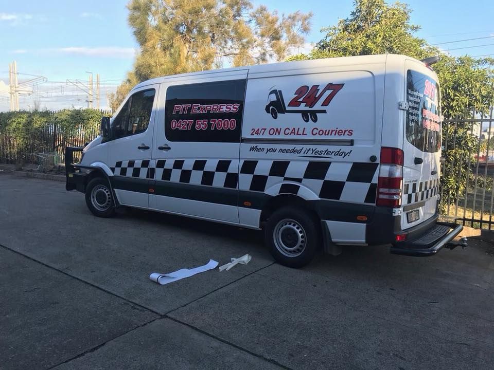 White Van With a Checkered Pattern is Parked on the Side of the Road — Pit Express in Welshpool, WA