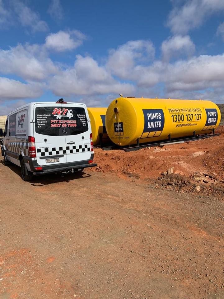 White Van is Parked Next to a Yellow Tank in a Dirt Field — Pit Express in Perth, WA