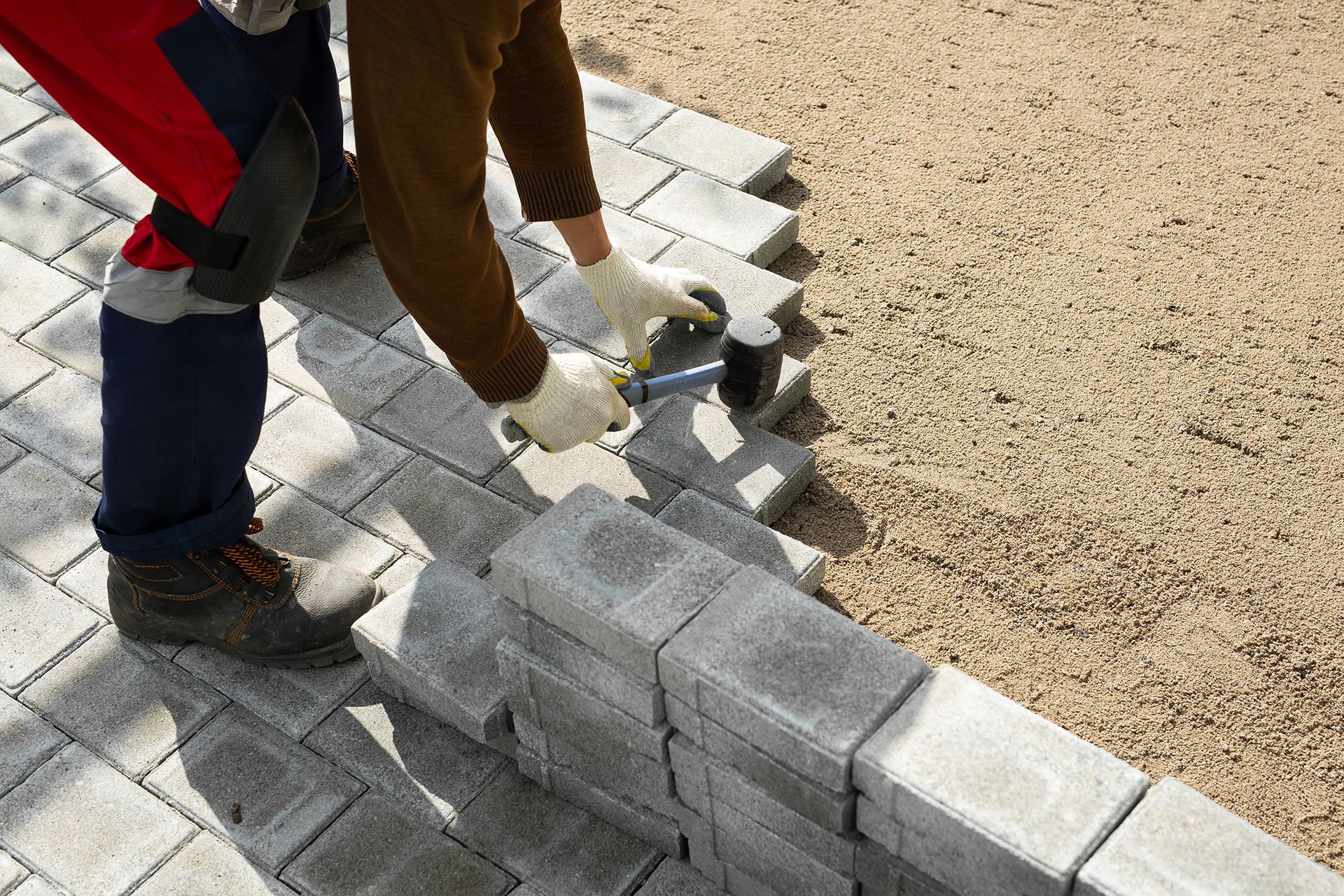 Concrete walkway installation and paver base preparation