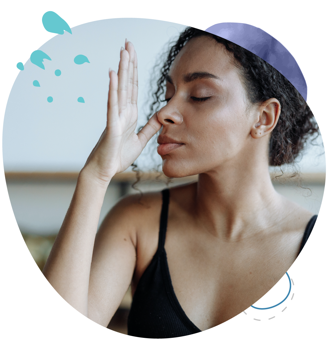 A woman with her eyes closed and her hand on her nose.