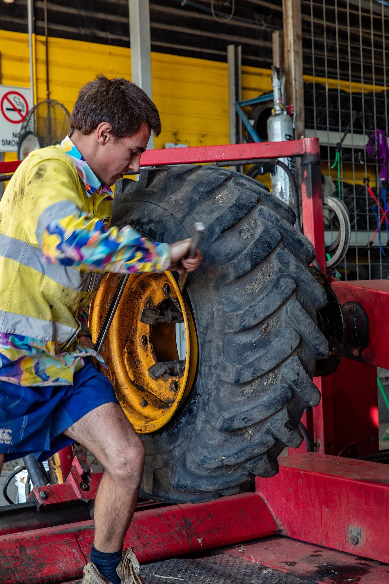 Truck Tyre replacements in Millmerran Queensland, A man is working on a large tire in a garage