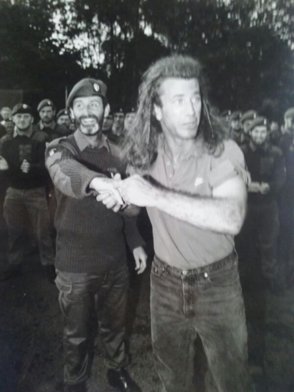 A black and white photo of two men shaking hands