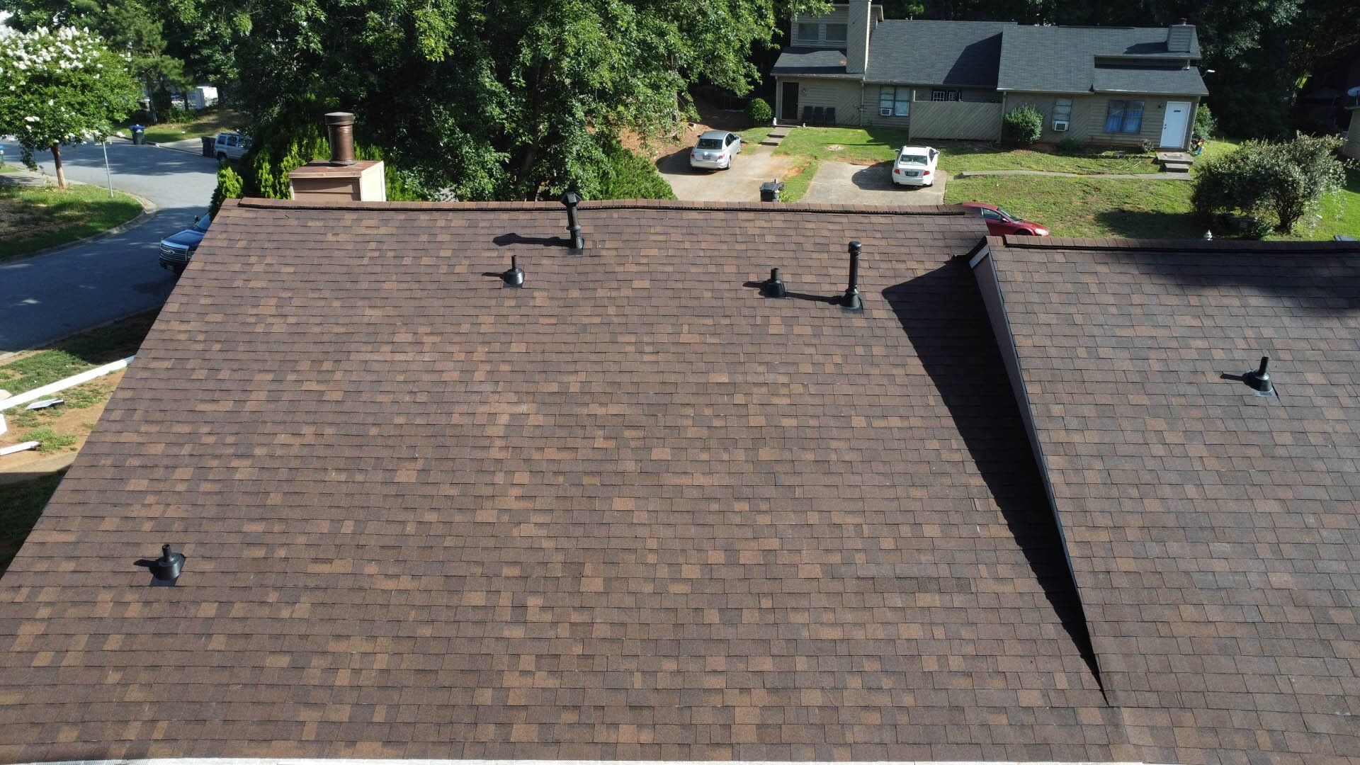 An aerial view of a roof with two chimneys on it