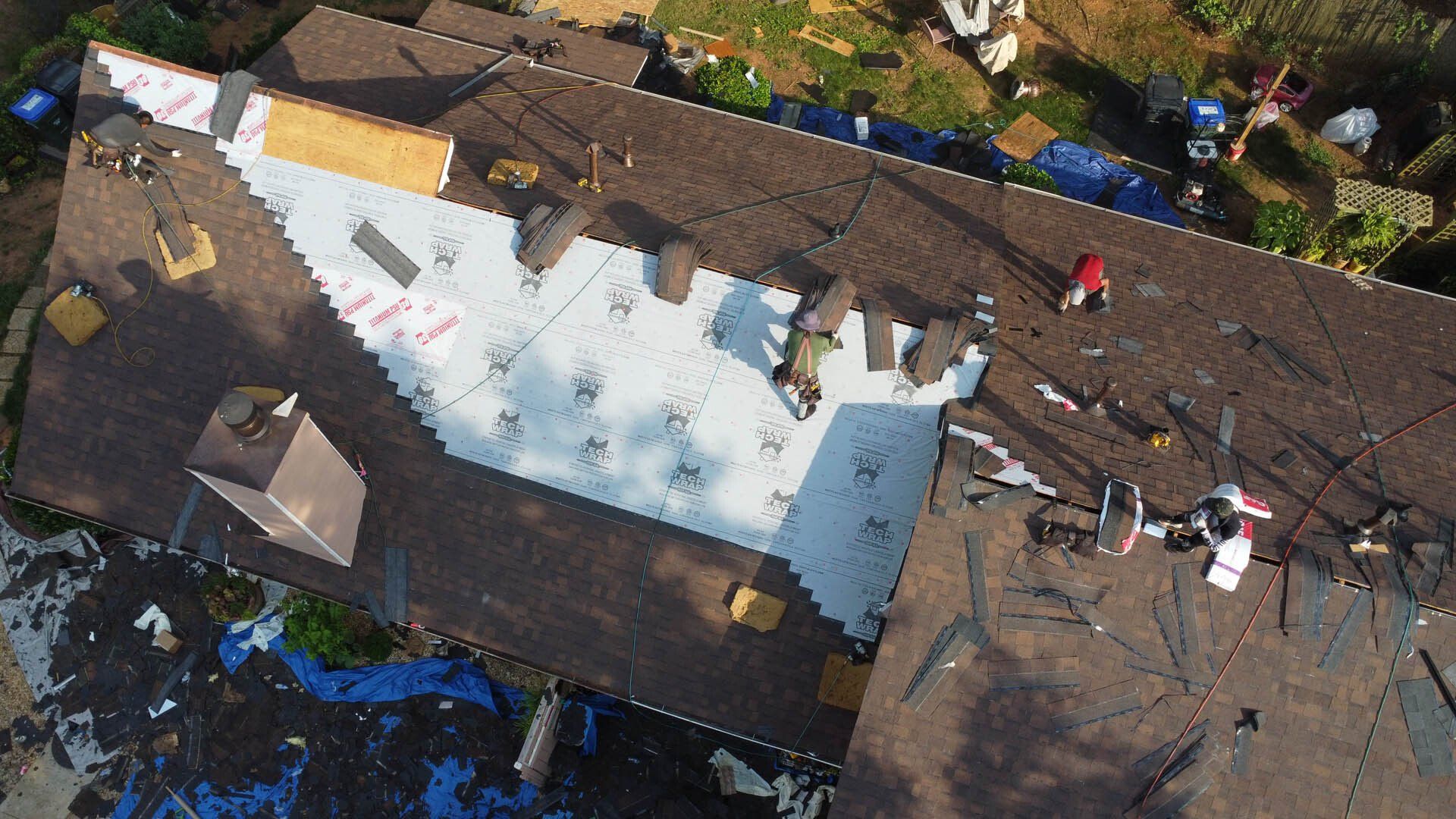 An aerial view of a roof that is being repaired
