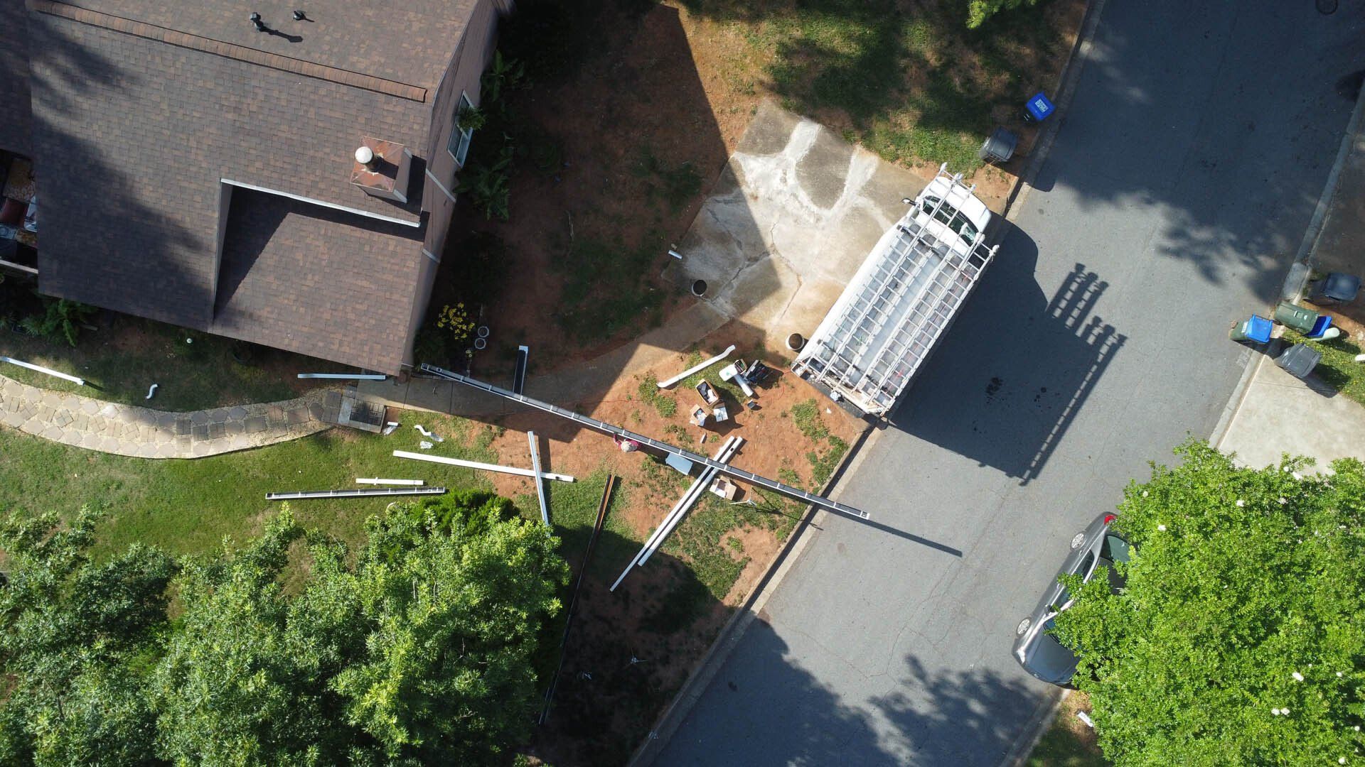 An aerial view of a house with a truck parked in front of it.