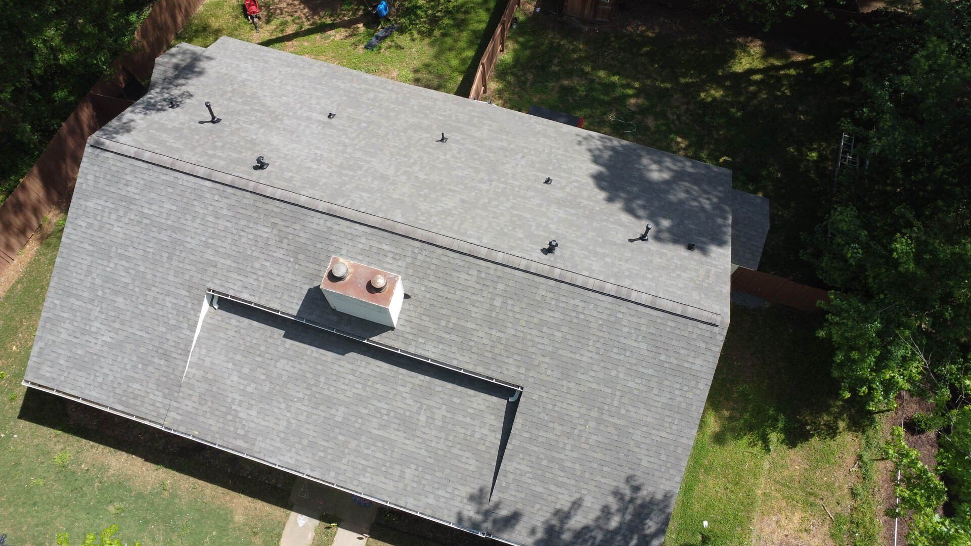 An aerial view of a house with a roof and a chimney.