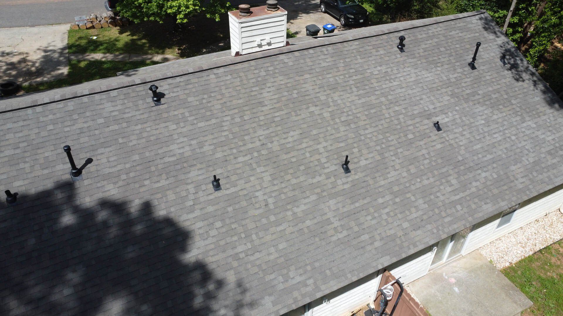 An aerial view of a roof with a few chimneys on it.