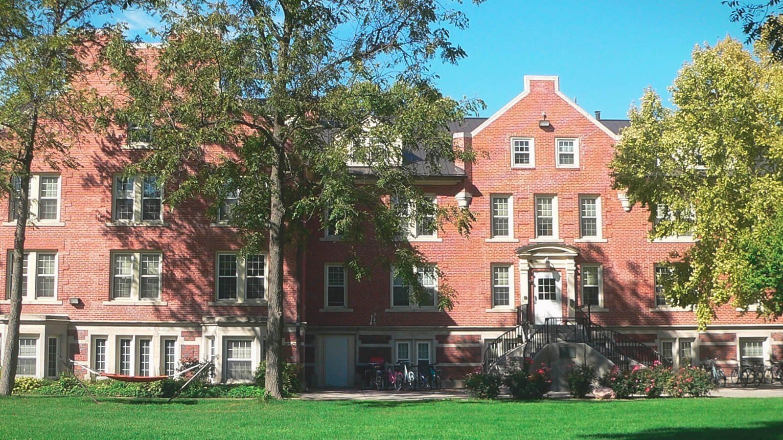 A large red brick building with trees in front of it