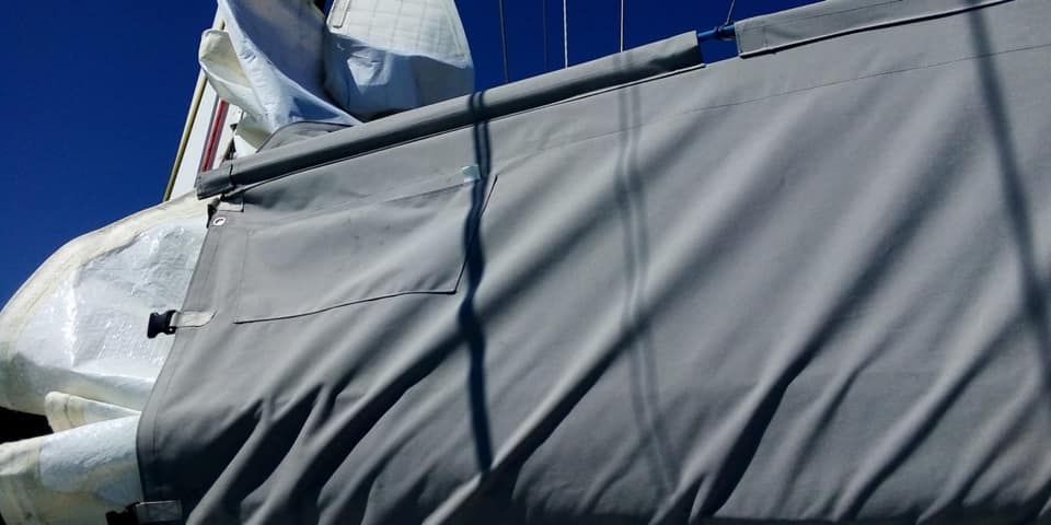 Primo piano di una barca a vela con una copertura grigia.