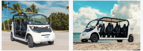 Two white open-air electric vehicles parked on a beach and road. One has a black roof and black seats.