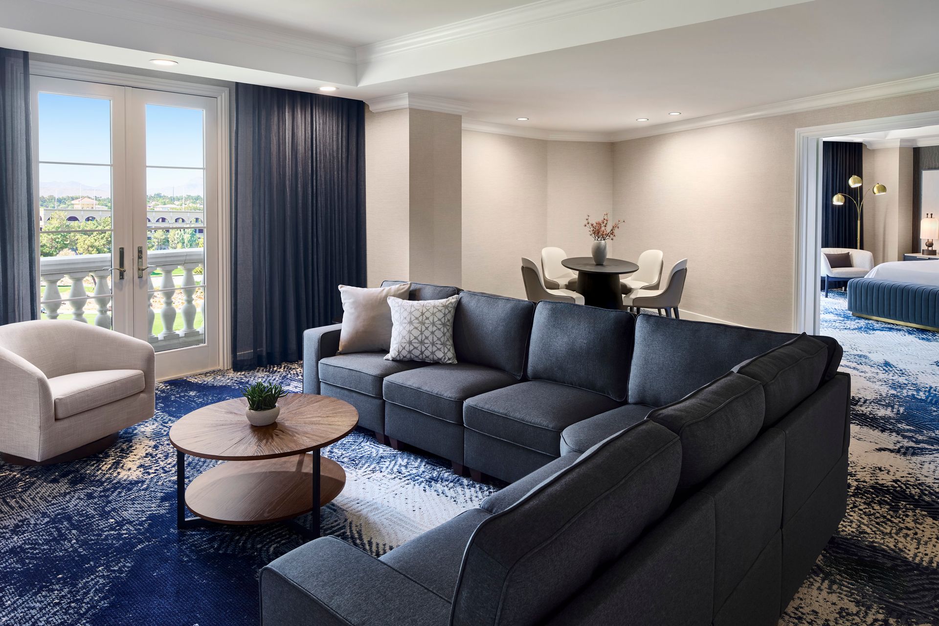 A living room with a couch , chair , table and window.