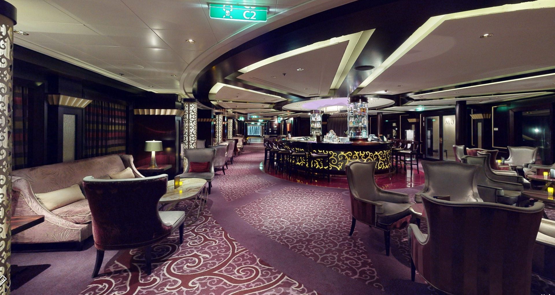 A large room filled with furniture and a bar on a cruise ship.