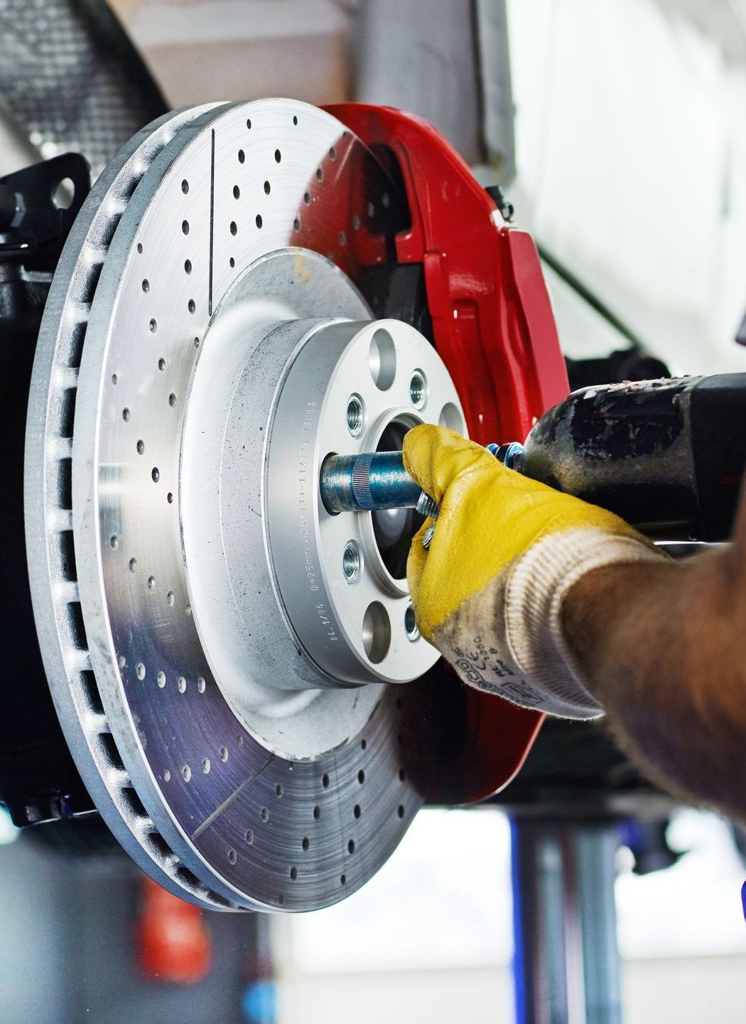 Mechanicworks on a car's brake rotor | Keegan Auto