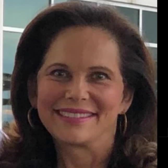 A close up of a woman 's face with a smile on her face.