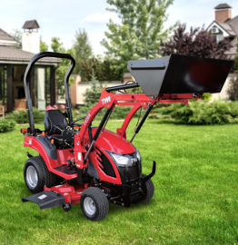 Red compact tractor with front loader and mower attachment on a green lawn in a suburban yard