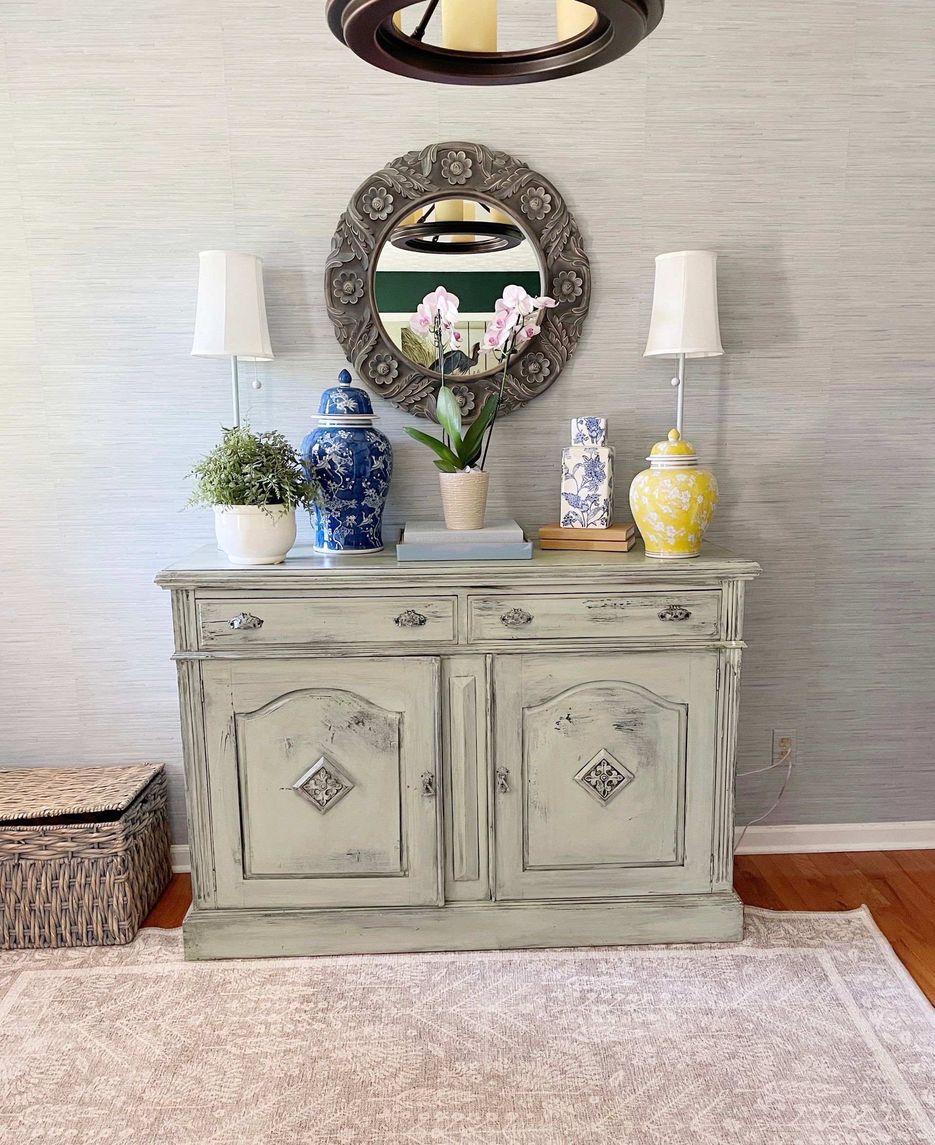 foyer with light blue peel and stick wallpaper, blue and white ginger jars with orchid