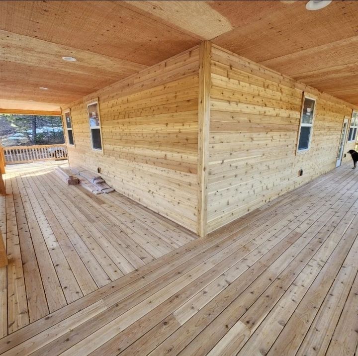 A wooden fence is being built in a backyard.