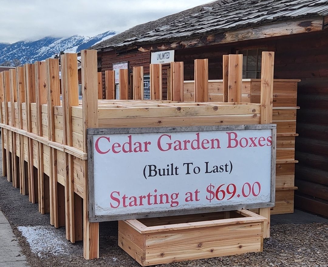 A sign that says cedar garden boxes starting at $ 69.00.