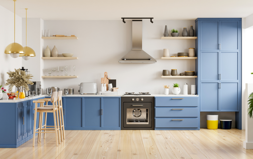 A kitchen with blue cabinets , a stove , and a sink.