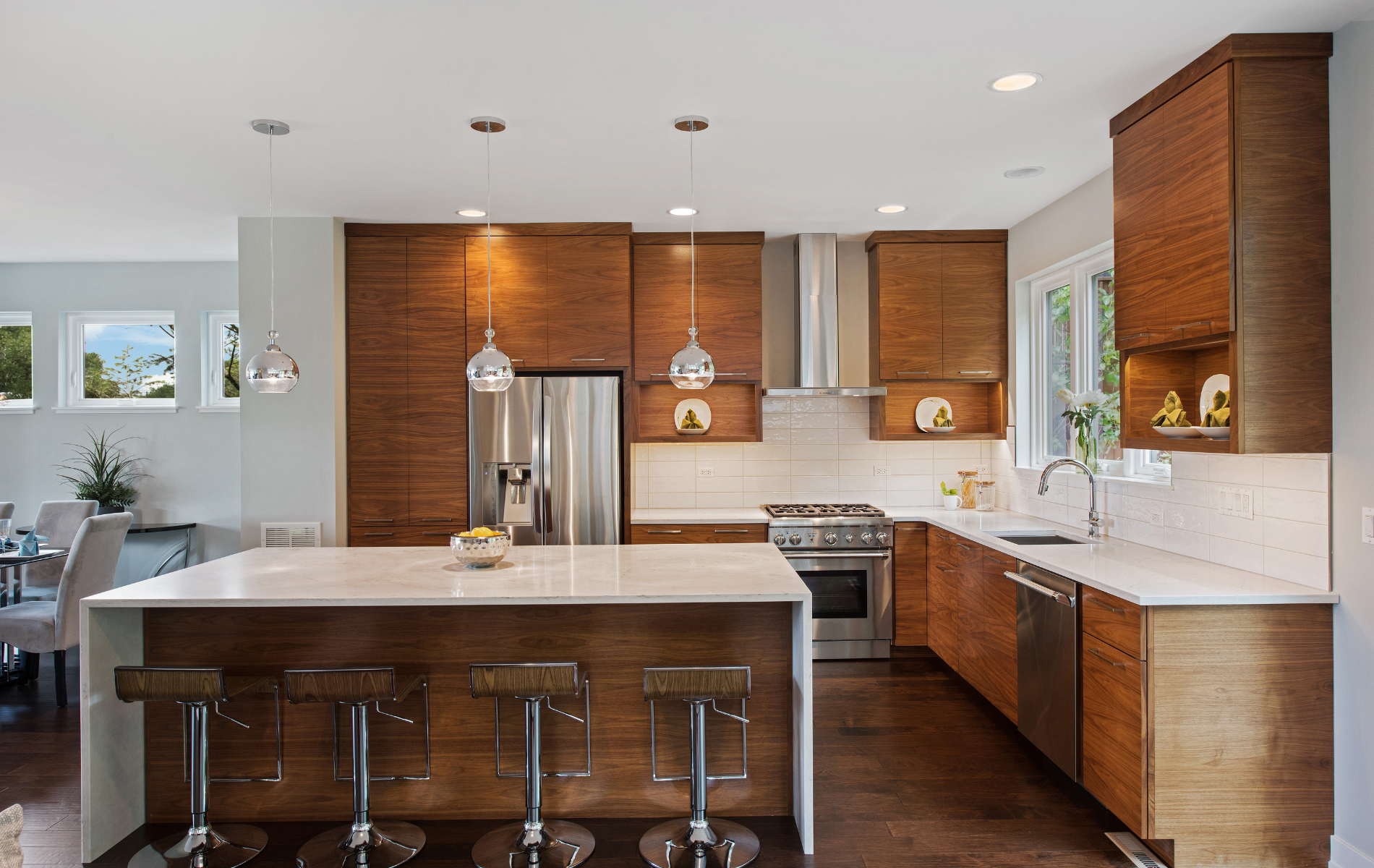 A kitchen with stainless steel appliances , wooden cabinets , and a large island.